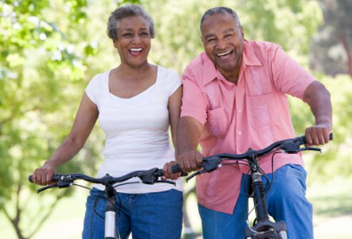 two senior adults bicycle image