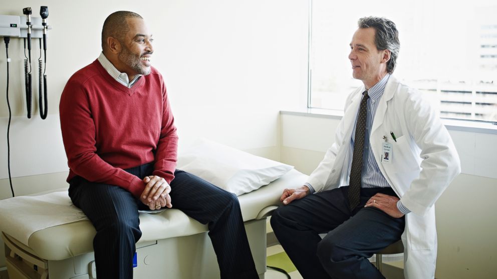 doctor sitting have conversation with male patient